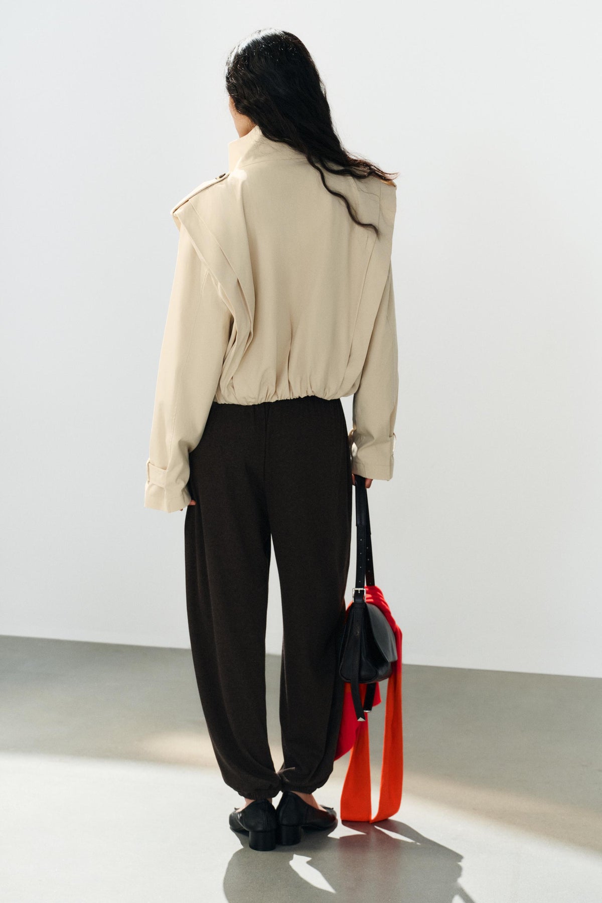 a SHARON SHORT PLEATED TRENCH COAT